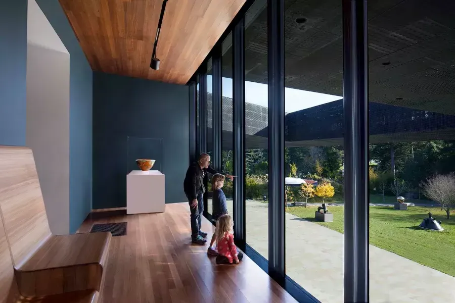 Family looking out the window at the de Young museum 